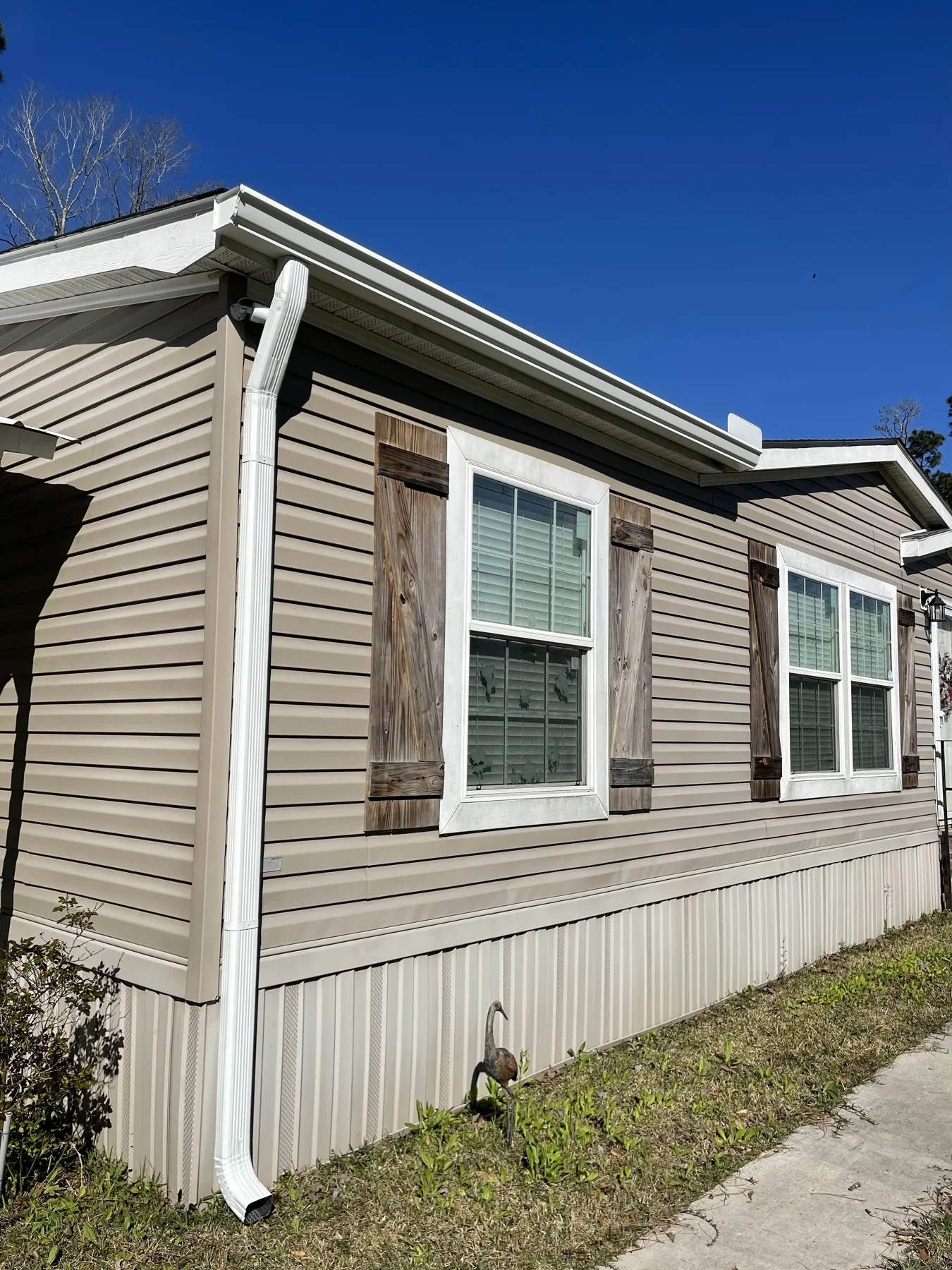 White gutter and downspout along siding