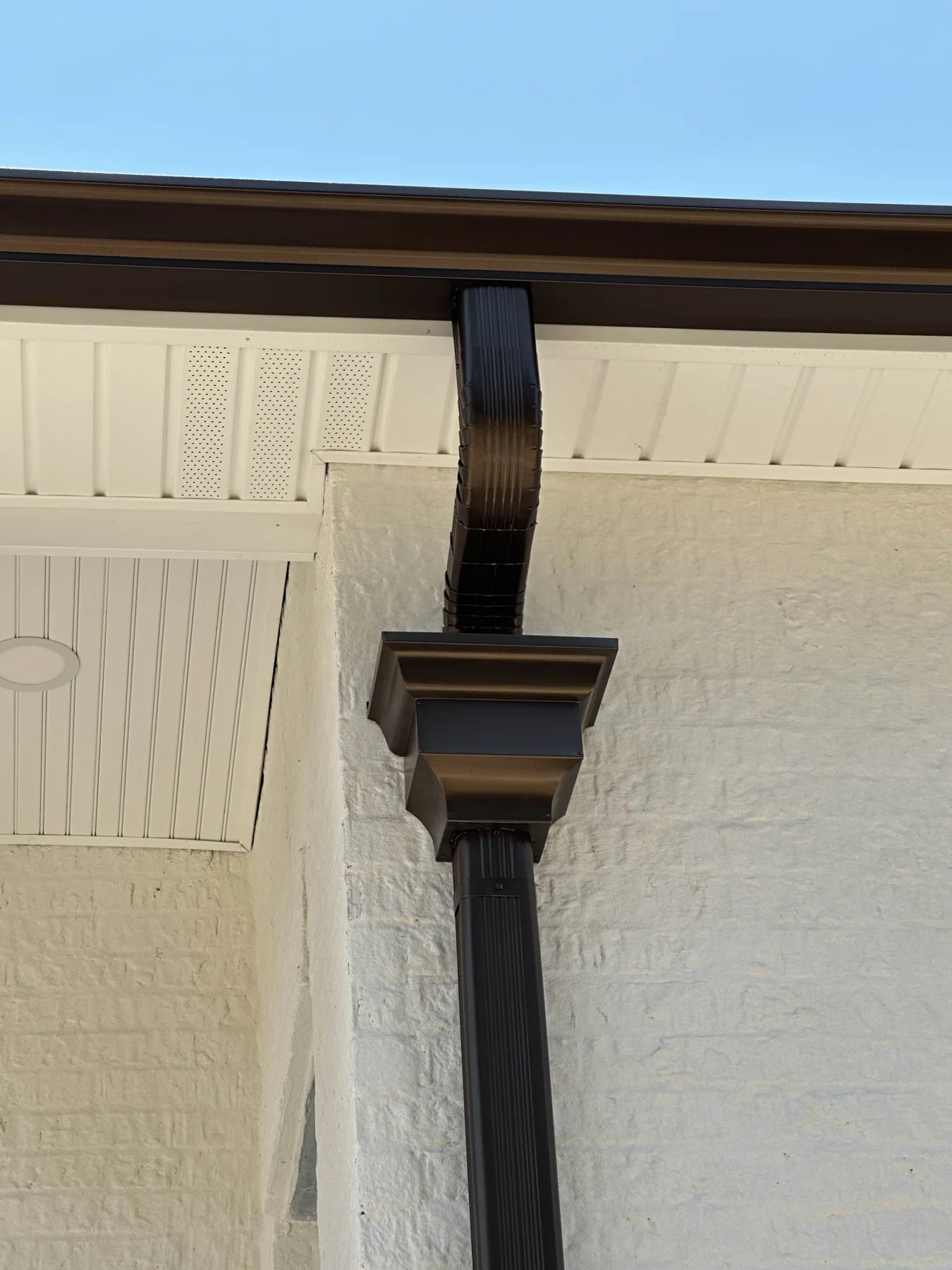 Close-up of a dark gutter outlet