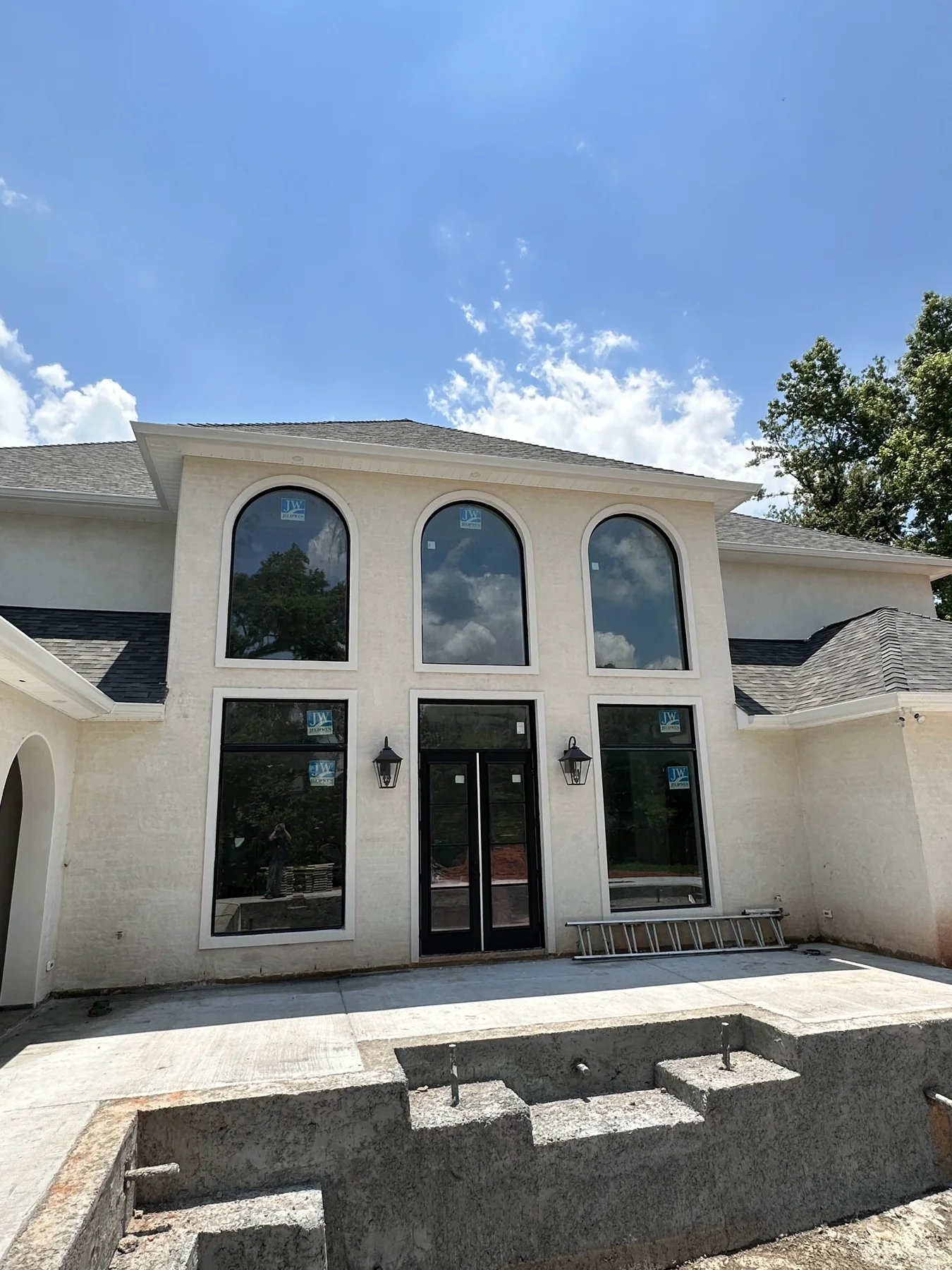 Gutter installation on a white two-story home