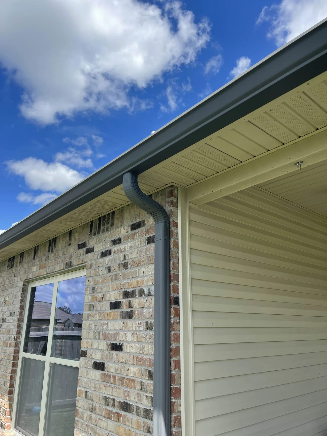 Gutter and downspout at a garage corner